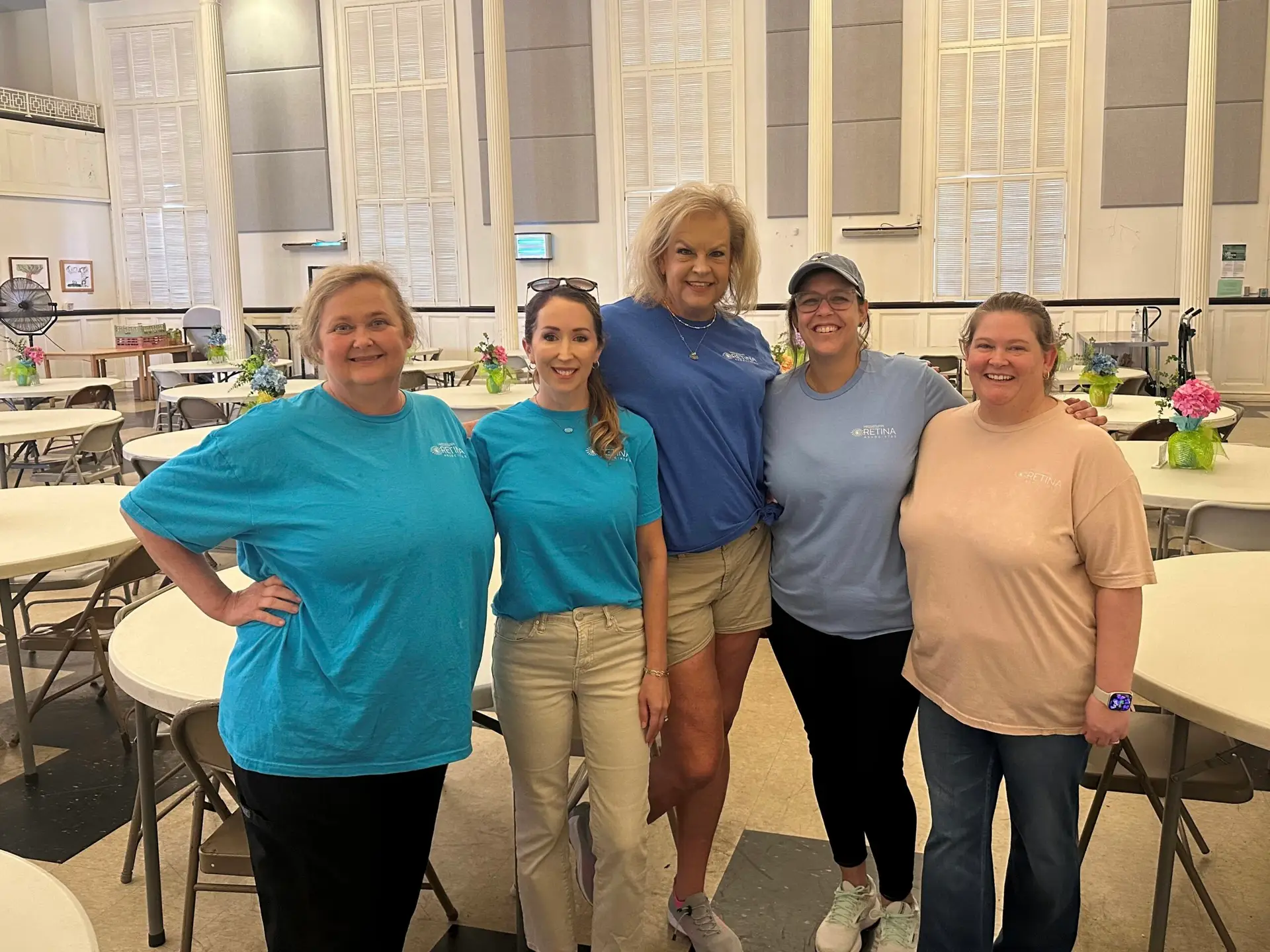 Members of the Mississippi Retina Associates team take a moment together while volunteering at Stewpot Community Services.