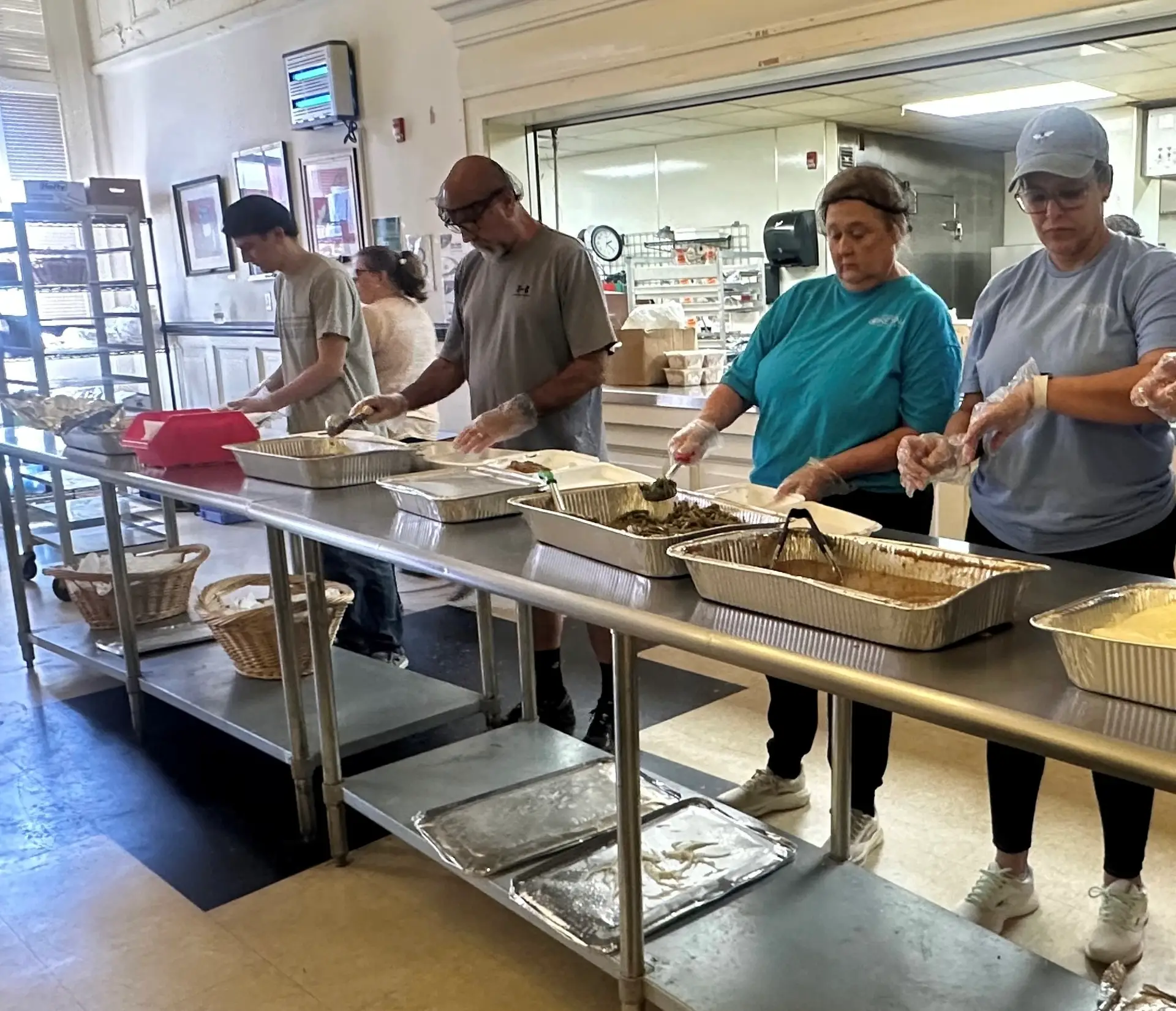 Volunteers from Mississippi Retina Associates help prepare and serve meals in the Stewpot Community Kitchen.